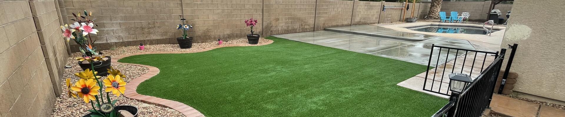 Happy customer in front  of completed Yuma landscaping project